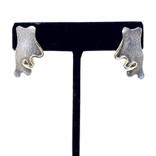 925Collection abstract stud earrings featuring textured matte silver and polished gold-tone accents on a display stand.