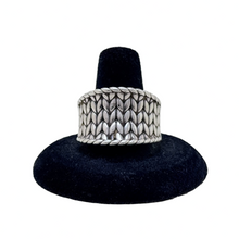 925Collection JAI sterling silver wide band ring featuring an intricate woven braided texture on a black display stand