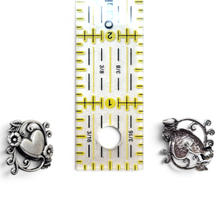 925Collection sterling silver heart stud earrings with intricate filigree and floral details next to a ruler.