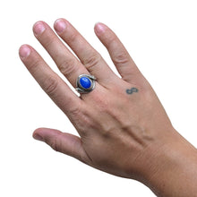 925Collection sterling silver statement ring featuring an oval lapis lazuli stone with an intricate snake motif band.