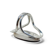 925Collection sterling silver statement ring with an open-work band and a deep red oval stone, side view.