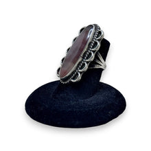 925Collection sterling silver statement ring with an elongated oval earthy stone, rope detailing, and scalloped edges.