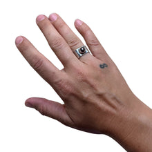 925Collection sterling silver statement ring with a dark pearl on a hand against a neutral background