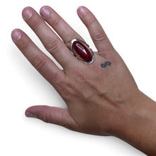 925Collection sterling silver statement ring featuring a deep red oval cabochon stone on a hand with a tattoo.