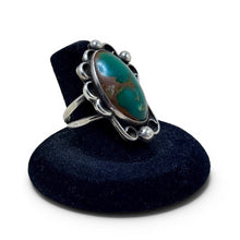925Collection sterling silver statement ring featuring an oval green turquoise stone with intricate scrollwork details.