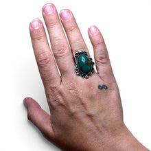 925Collection sterling silver statement ring featuring an oval green turquoise stone with intricate scrollwork details.