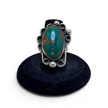925Collection sterling silver statement ring featuring an oval turquoise stone with intricate scrollwork and bead accents.