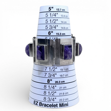 Bracelet measuring tool with purple stones on a white background
