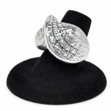 Silver ring with textured design on a black stand against a white background